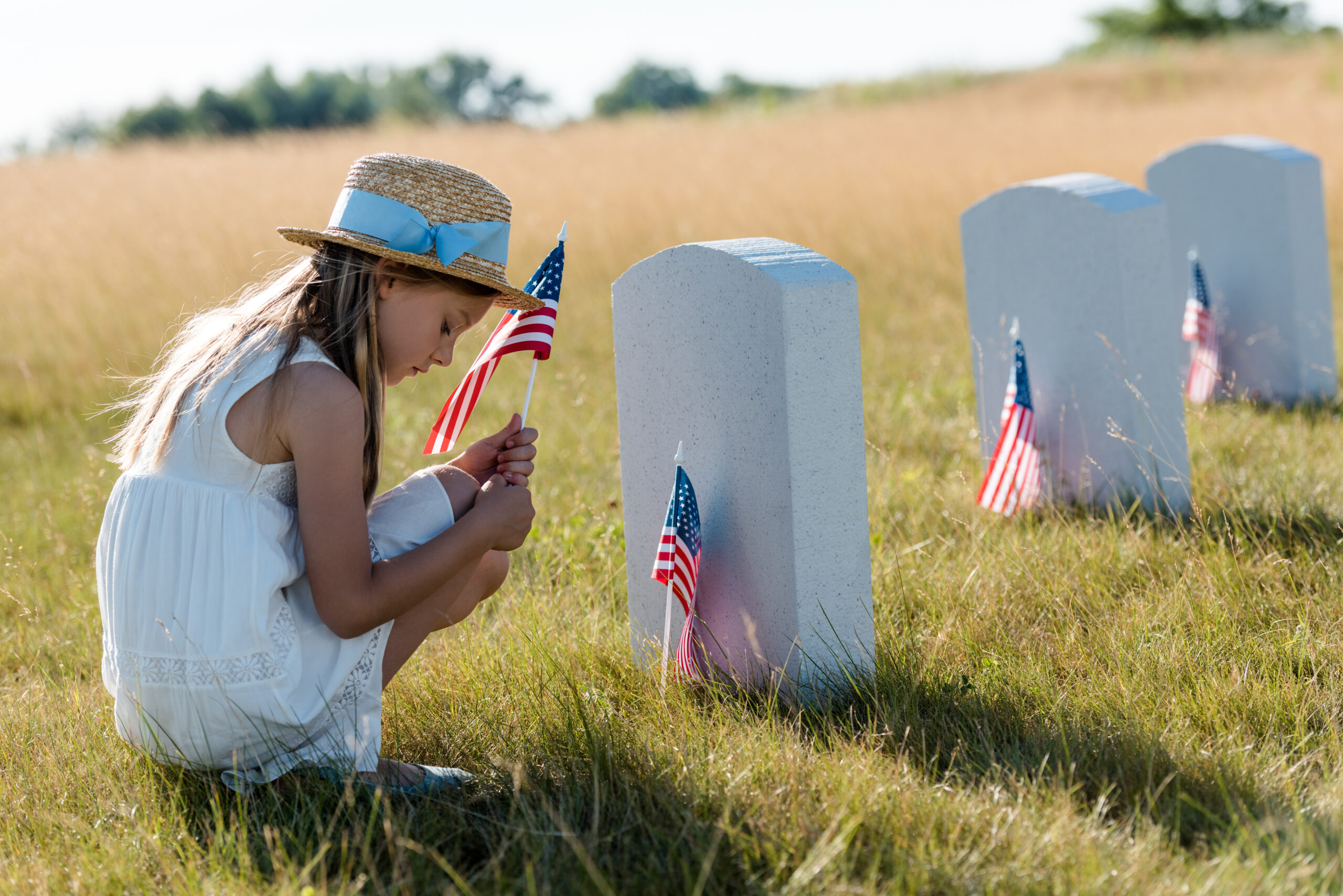 a girl kneeling by her mothers grave honoring her mother